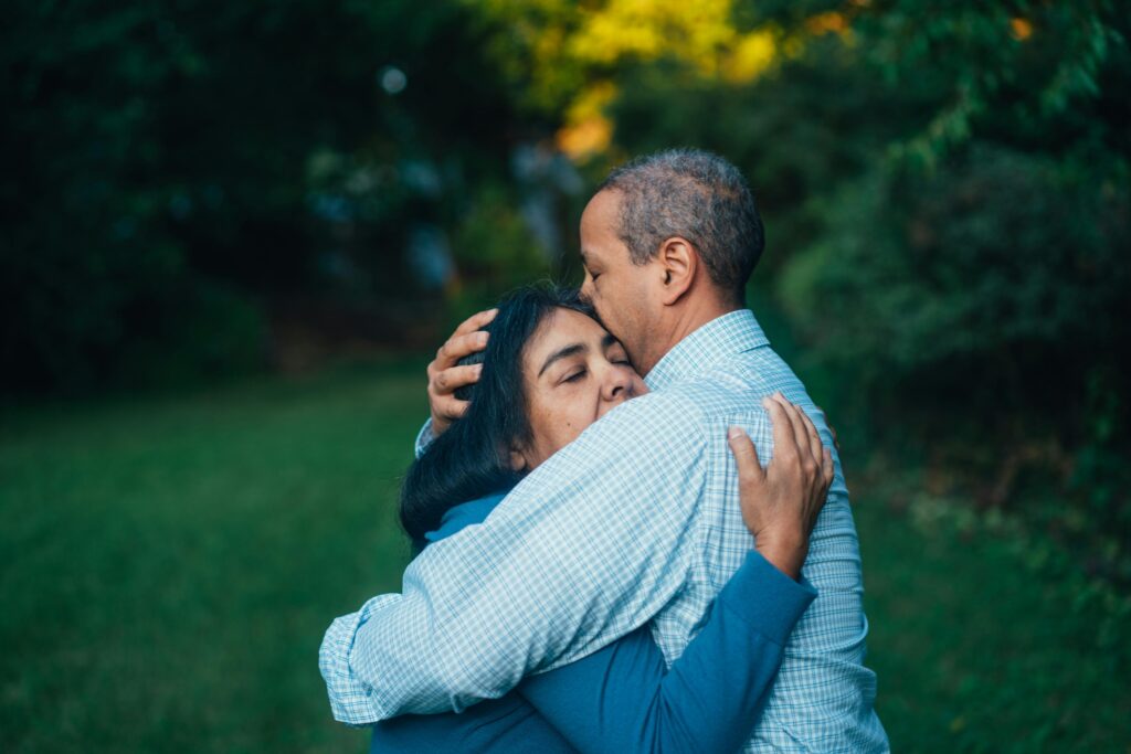 older couple embracing each other in support