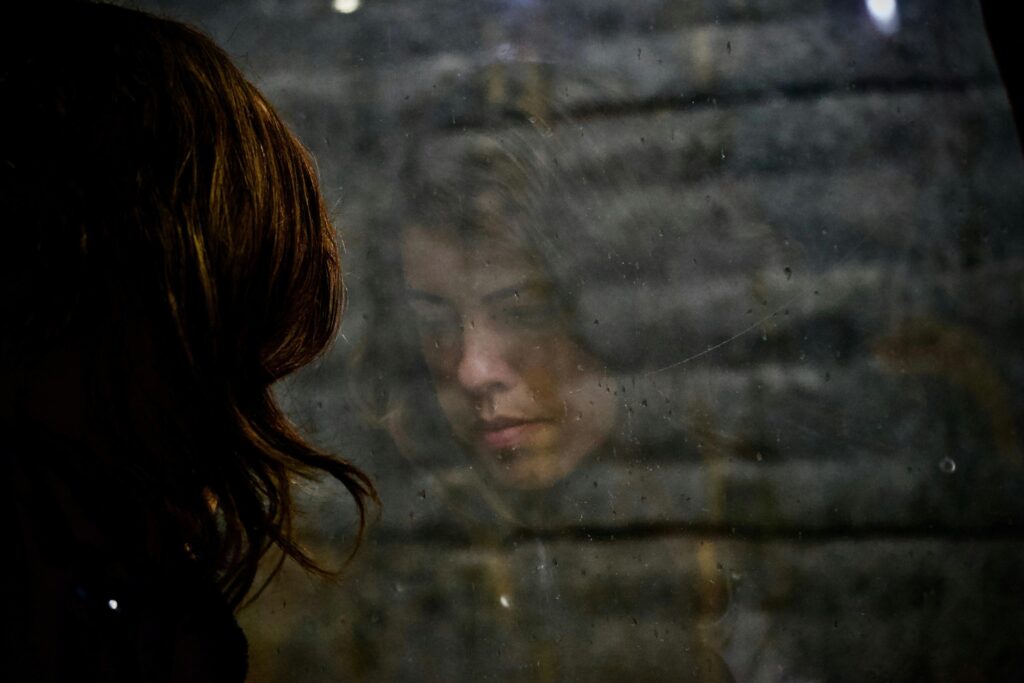 woman dealing with anxiety and depression looking out of window.